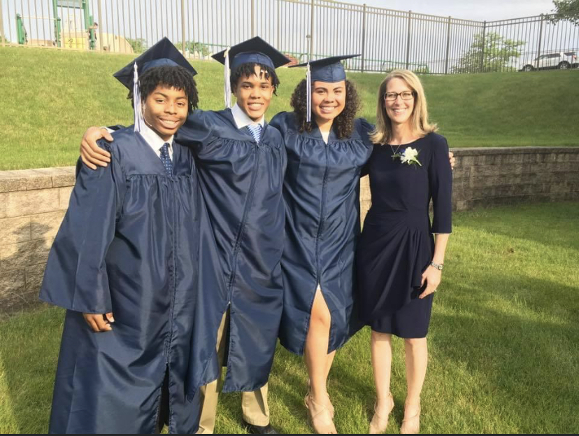 Superintendent Dr. Felty with three graduates